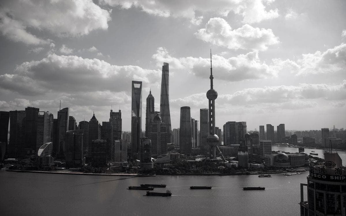 Black-and-white photograph of the Shanghai skyline and the Oriental Pearl Tower across the river
