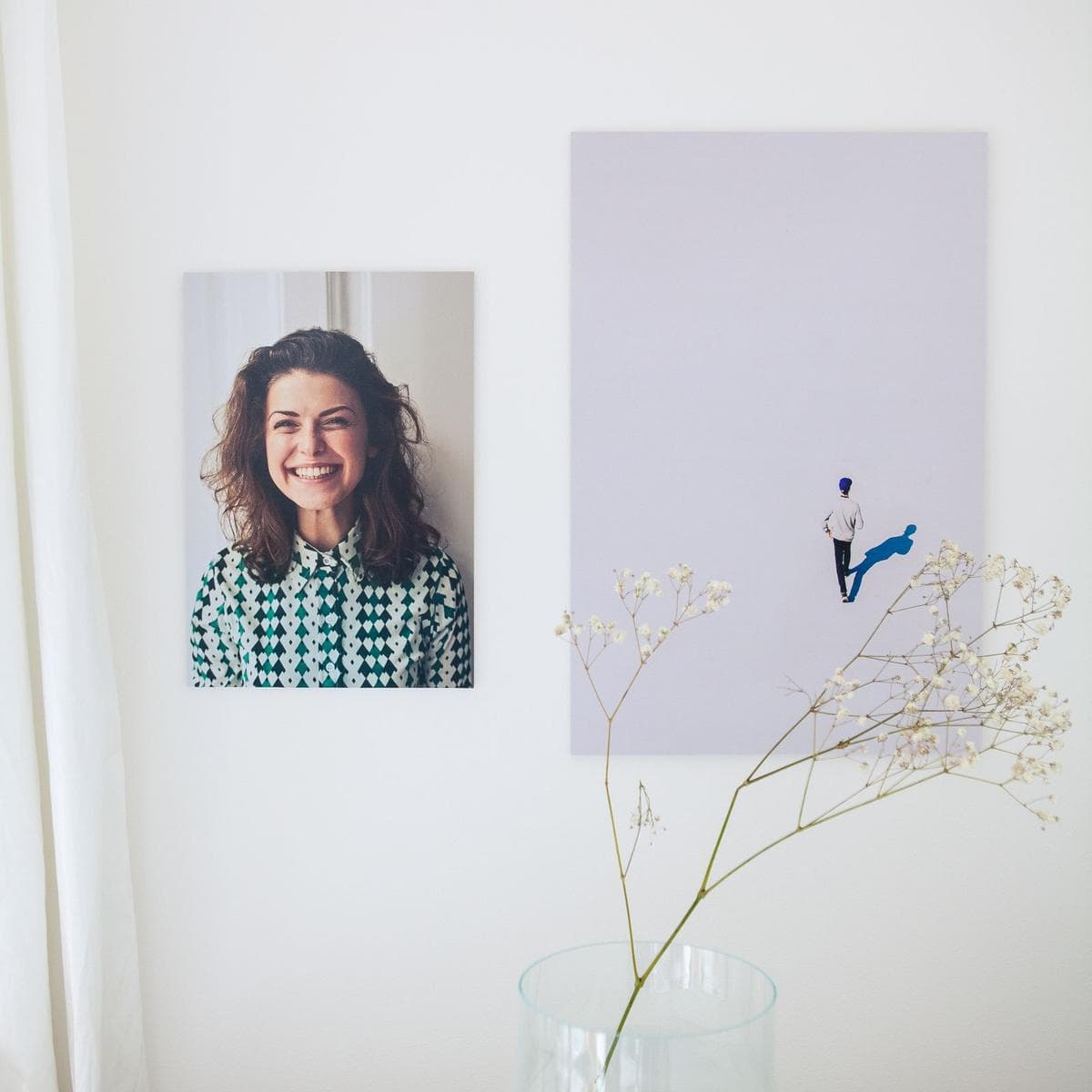 Photo portrait print and a large canvas-style print hanging side by side on a white wall