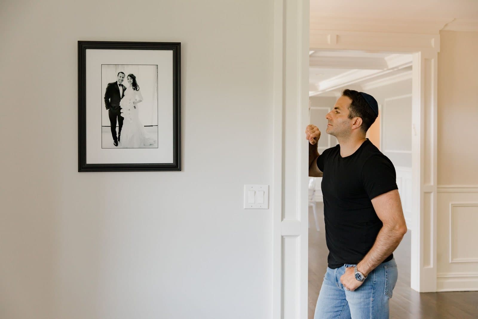 A framed black-and-white wedding photograph hanging on a hallway wall.
